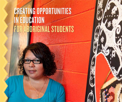 Indigenous woman student in front of red wall.