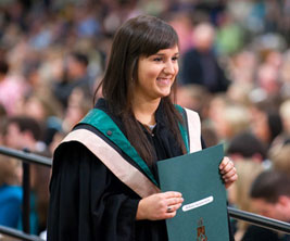 Bachelor female student holding a file