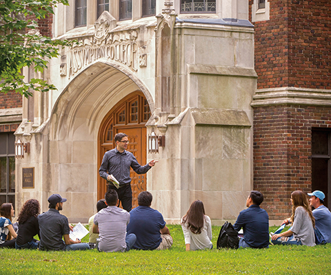 Teacher giving lecture to students on university Garden